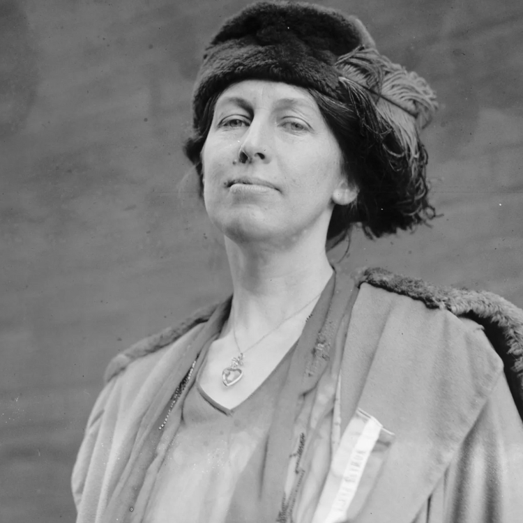 A historical black-and-white portrait of Nora Stanton Blatch Barney, a civil engineer and advocate for women in STEM. She is wearing a fur hat looking down on camera.